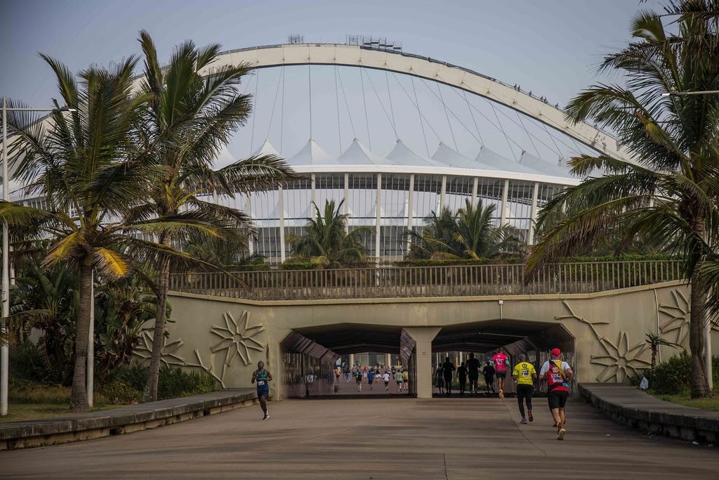 Runner on coastal road at dawn